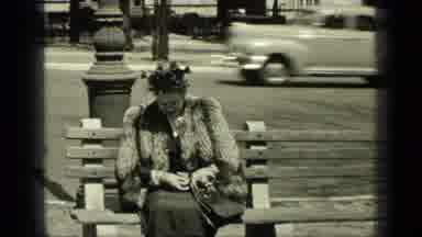 New York (1949): Woman Wearing Fur Stole Sits On Park Bench On A Bright Sunny Day