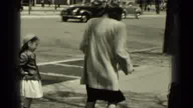 New York (1949): Woman Wearing Grey Coat Plays Hopscotch With Kids On A Sunny Day