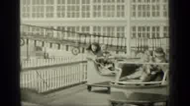 New York (1949): People Having Fun On The Wheel Toy Of An Amusement Park In The