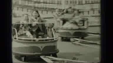 New York (1949): People Enjoying A Carnival Ride That Spins Around