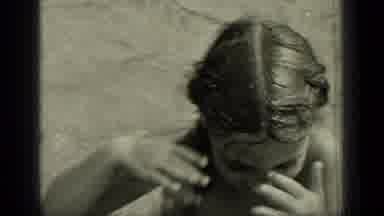 New York (1949): Young Dark Haired Female With Braids Rubs Eyes While In Water;