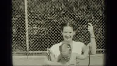 New York (1949): Woman Plays On Swing In Playground On Sunny Day And Family