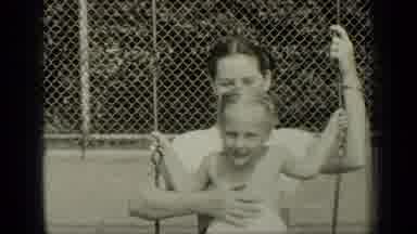 New York (1949): Woman Plays With Her Daughter On Toy In Sunny And Hot Day