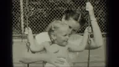 New York (1949): A Mother And Her Little Girl Swinging On A Swing Smiling And