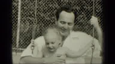 New York (1949): Man Wearing White Shirt Swings Girl Sitting Lap On A Clear Day