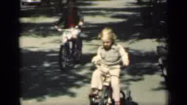 New York (1949): An Older Child Riding Their Bike Past A Younger Child