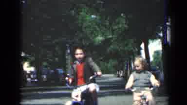 New York (1949): Two Young Girls Are Riding Bikes Together Through A Park