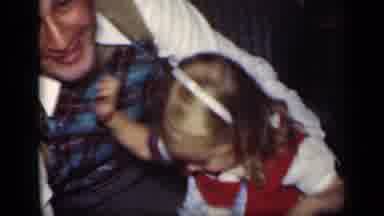 New York (1949): Child Playing With Dad In House With Kiss On The Cheek And Woman