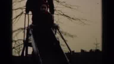 New York (1949): Boy And Girl In Winter Clothing Sliding Down A Slide At A