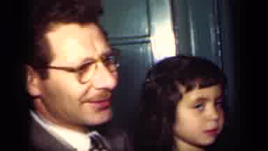 New York (1949): Girl Sitting Next To Man Wearing Grey Suit Gives Cameraman Stern