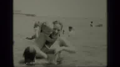 New York (1949): Woman Holds Baby In Waist High Water On A Sunny Day
