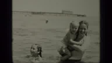 New York (1949): Women Holding Her Child In The Lake As People Behind Them Swim