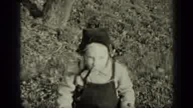 New York (1949): Kid Standing In The Grass In Front Of A Tree Then Person Riding