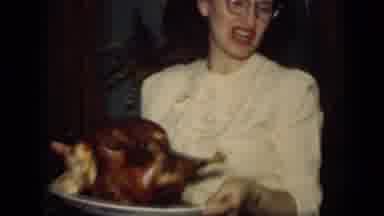 New York (1949): Woman Wearing Glasses Holds Platter With Roasted Turkey On It In