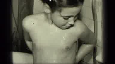 New York (1957): Child Smiles For The Camera As They Wash Their Back Under The