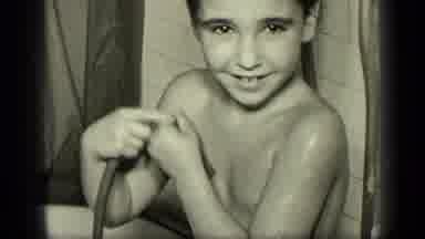 New York (1957): A Child Standing In A Bathtub Rinser With Hose And Then Wraps