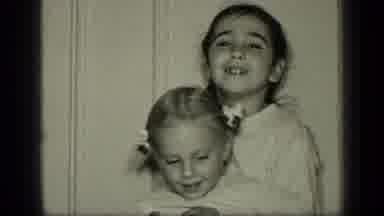New York (1957): Girl Wearing White Shirt Holds Girl Wearing White Hair Ribbons