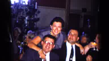 New York (1957): Woman Wearing Blue Dress Talks With Three Men Wearing Black Suits