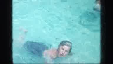 New York (1957): Young Women Wearing A Blue Bathing Suit Is Swimming In A Pool