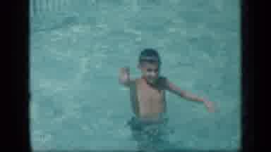New York (1957): Small Boy Smiling Waving And Swimming In Pool Of Water
