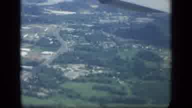 New York (1957): Aerial View Of A Small City Followed By A Man And Some Luggage