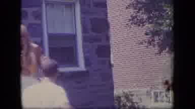 New Jersey (1970): A Women Coming Outside Runs Quickly To Meet Someone Outside