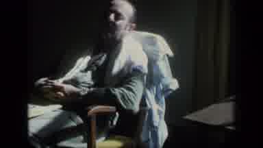 Puerto Rico (1970): Man Wearing Green Shirt Naps In Brown Chair By Window On A