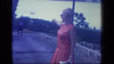 Puerto Rico (1970): Beautiful Tourist In A Red Dress Pointing Out A Blimp In The