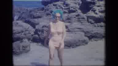 Puerto Rico (1970): Woman On A Beach Rocks Surrounded By A Large Body Of Water