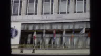 Moscow Russia (1971): Camera Pans Across The Large Building That Had Many Flags
