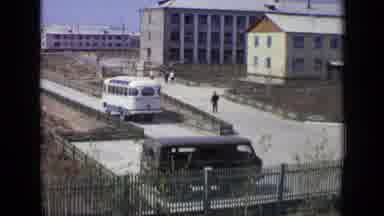 Moscow Russia (1971): Bus Driving Down Street And People Walking Through A Gate