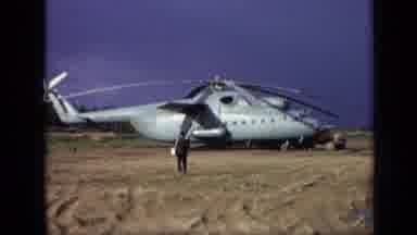 Moscow Russia (1971): Person Walks Toward Military-Style Helicopter Landed In Open