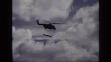 Moscow Russia (1971): Helicopter Flying As Its Carrying Something Big And Long