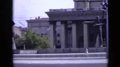 Moscow Russia (1971): Cars Driving And People Walking In Front Of A Building With