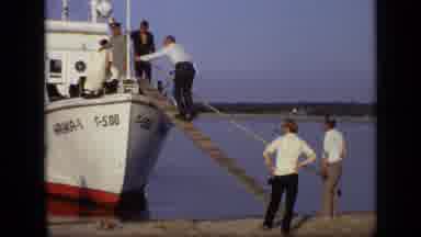 Moscow Russia (1971): Man Walks Gangplank Onto Medium-Sized Boat As Others Watch