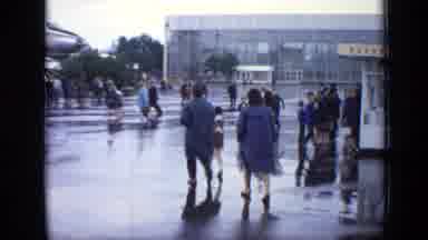Moscow Russia (1971): People Walking On A Wet Sidewalk Towards A Big Plane
