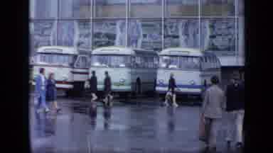 Moscow Russia (1971): People Walking Past Parked Buses On A Rainy Day