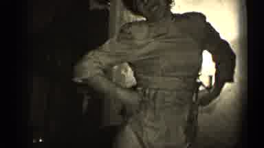 Illinois USA (1947): Woman Strikes A Pose And Then Hugs And Kisses Man