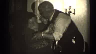 Illinois USA (1947): An Elderly Man And Woman Laugh Together As He Tries To Get