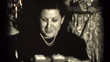 Illinois USA (1947): A Woman In A Black Dress Wearing Pearls Holds A Tray Of Items