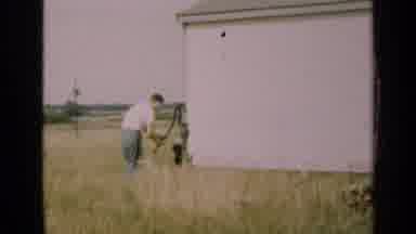 Illinois USA (1947): Pumping Water Outside With The Dog