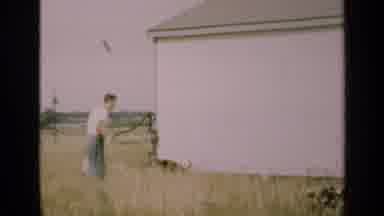 Illinois USA (1947): Man Wearing White Shirt Pumps Water From Outdoor Waterpump On