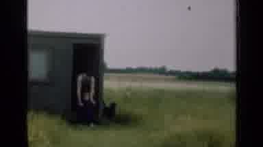 Illinois USA (1947): Farmer In Overalls Walks With Child And Dog Through A Field