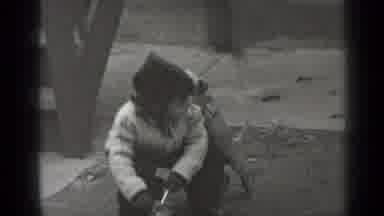 New York (1947): As A Small Child Crouches Down A Small Dog Puts Front Paws Up On