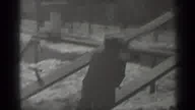 New York (1947): Child Wearing Black Coat Sits On Seesaw On A Bright Sunny Day