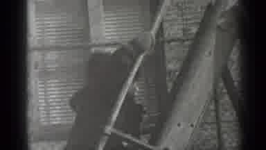 New York (1947): Girl Wearing Grey Coat Climbs To Top Of Slide Ladder On A Sunny