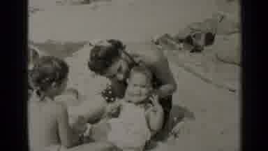 New York (1947): Mother Sitting With Her Two Small Children On A Sandy Beach In