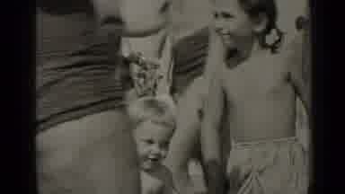 New York (1947): Mom Is Holding Kids Hands As They On The Beach With The Other