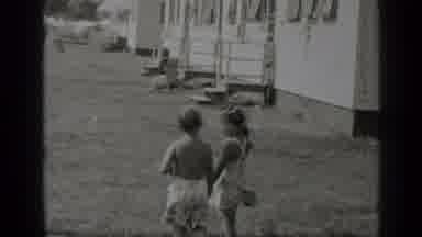 New York (1947): Woman Stands In Front Of A White House Holding Hands Of Two