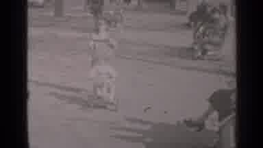 New York (1947): Child Wearing White Shirt Rides Tricycle On A Bright Sunny Day